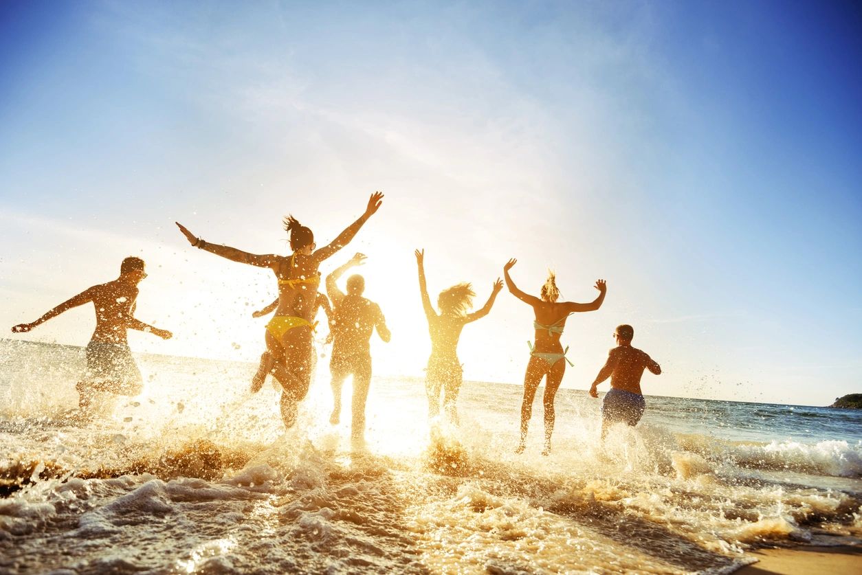 A group of people running in the water.