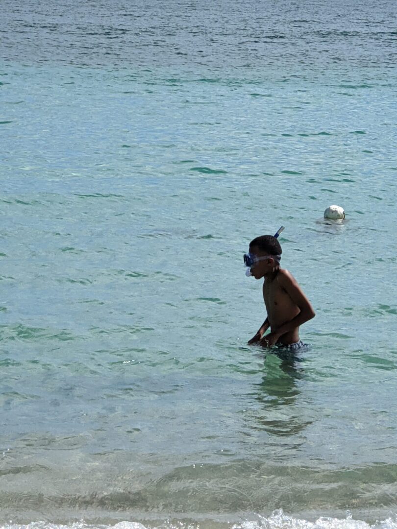 A man in the water with a mask on.